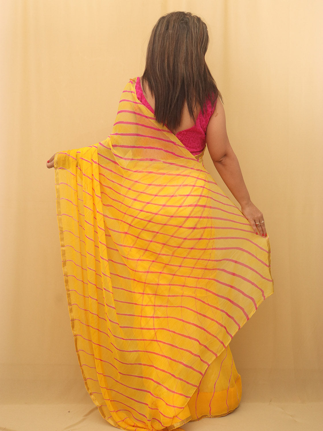 Yellow fancy chiffon saree features intricate sequin stripe design  embroidery all over the saree, plain border